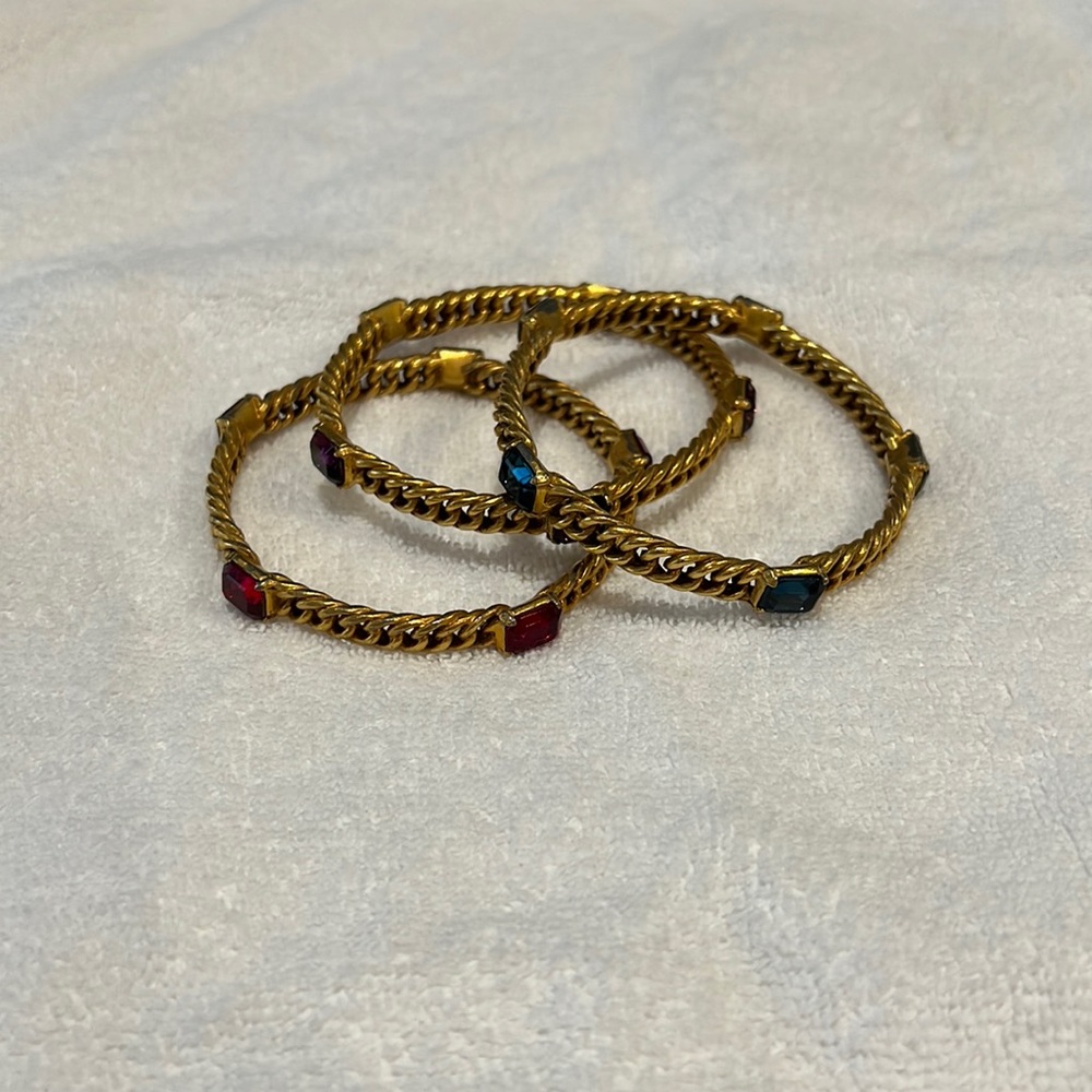 Set of 3 costume jewelry bangle bracelets. Stones are purple, red, and blue